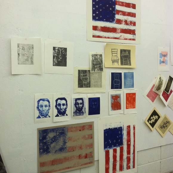 Some of my prints from Day 1 and 2 of the workshop. I printed a backward American Flag. After hours of explaining the backward printmaking deal to my students I committed the crime myself. It's the vertical one hung that way in an attempt to trick your mind.